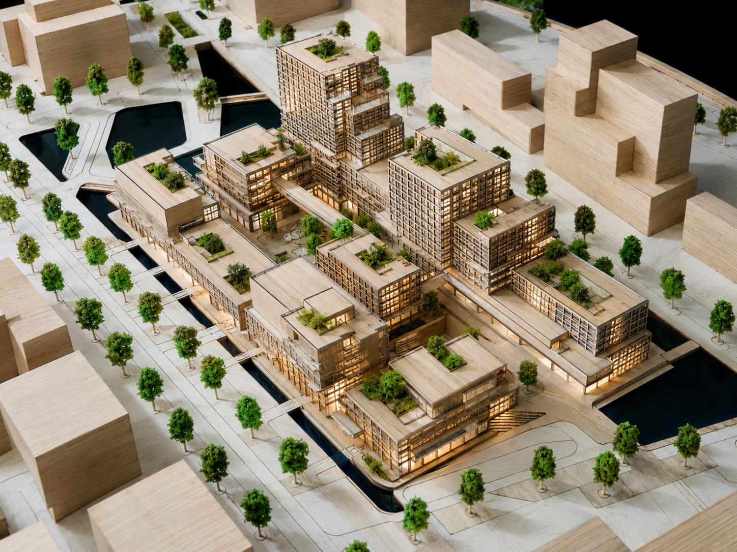 Architectural scale model of a layered residential masterplan with rooftop gardens and waterways